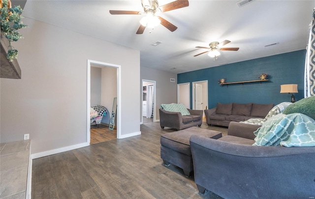 living room featuring dark hardwood / wood-style flooring and ceiling fan