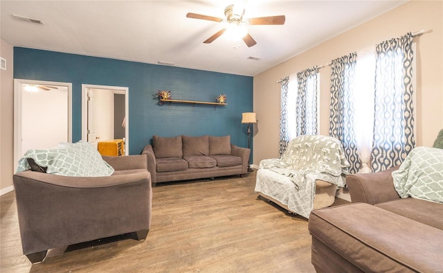 living room with ceiling fan and light hardwood / wood-style floors