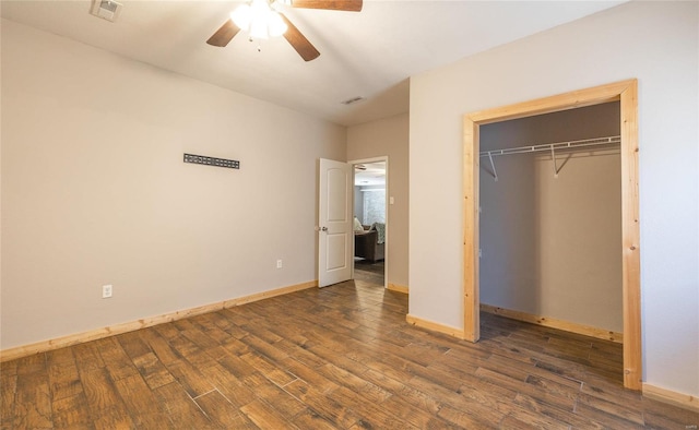 unfurnished bedroom featuring ceiling fan, a closet, and dark hardwood / wood-style floors