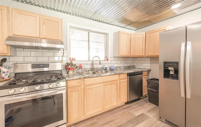 kitchen with decorative backsplash, sink, light hardwood / wood-style flooring, appliances with stainless steel finishes, and light brown cabinetry