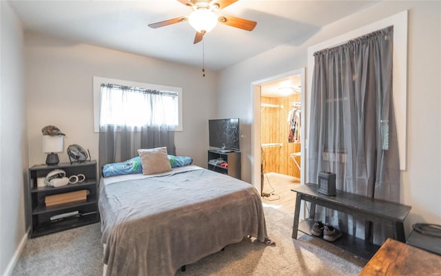 carpeted bedroom with ceiling fan and ensuite bathroom