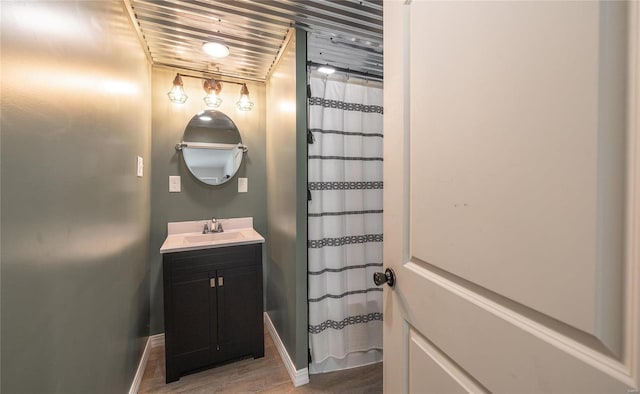 bathroom with curtained shower, wood ceiling, hardwood / wood-style floors, and vanity