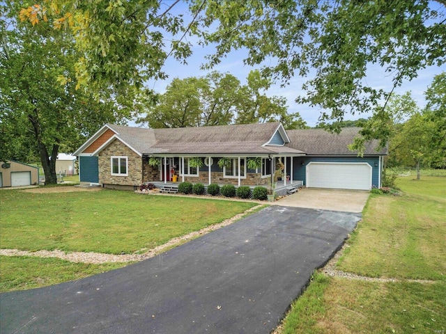 single story home featuring a front lawn, covered porch, and a garage