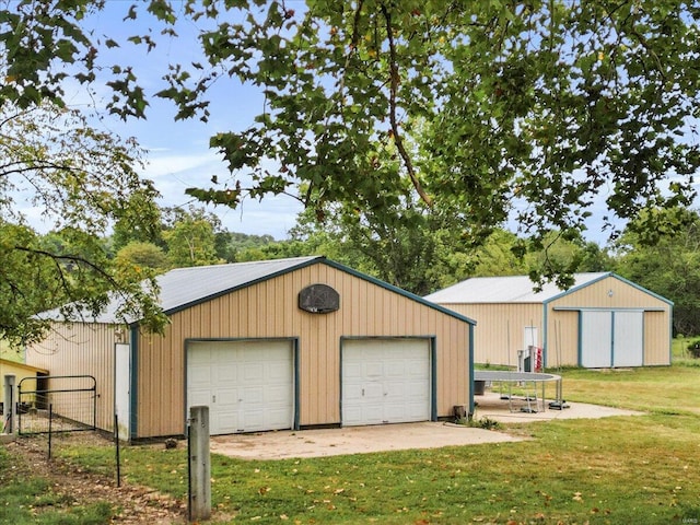 garage featuring wood walls and a lawn