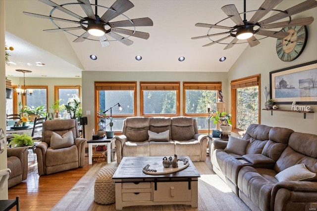 living room featuring ceiling fan, light wood-type flooring, and high vaulted ceiling