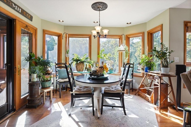 interior space featuring a wealth of natural light, a chandelier, and wood-type flooring