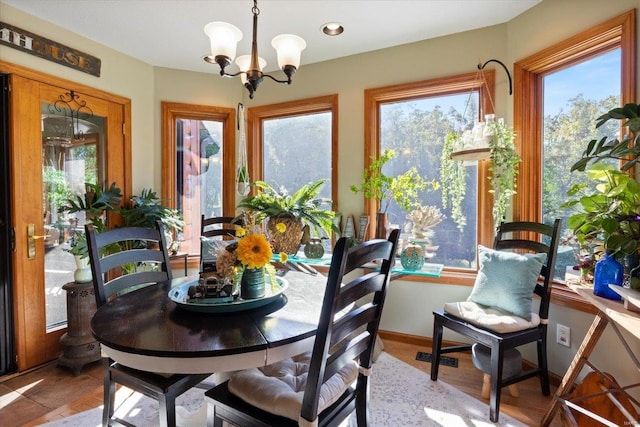 dining room featuring light hardwood / wood-style flooring, a chandelier, and a healthy amount of sunlight