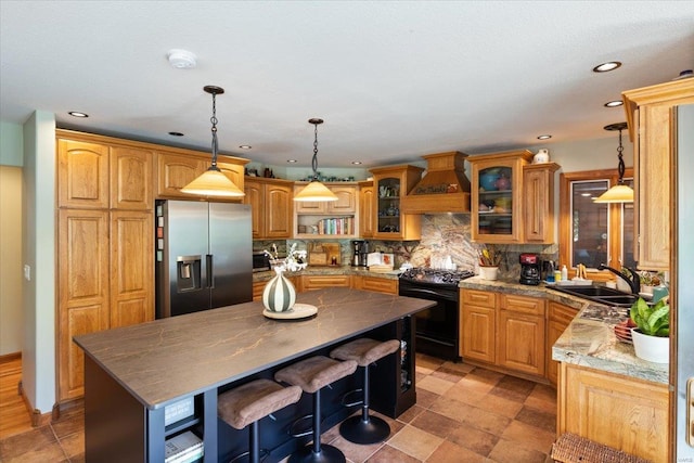 kitchen featuring black range with electric cooktop, a center island, custom exhaust hood, stainless steel refrigerator with ice dispenser, and sink