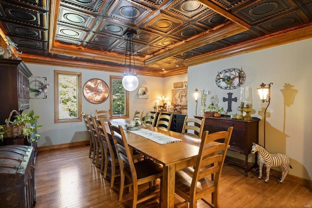 dining room with hardwood / wood-style flooring and ornamental molding