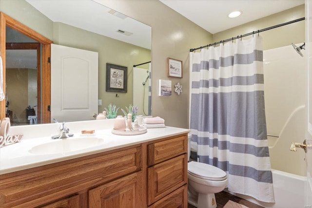 full bathroom featuring shower / tub combo, vanity, and toilet