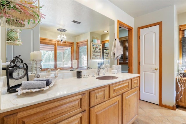 bathroom featuring vanity, a chandelier, and tile patterned flooring