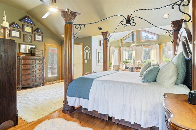 bedroom with lofted ceiling, multiple windows, and hardwood / wood-style flooring