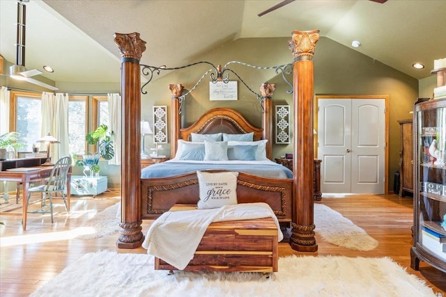 bedroom featuring a closet, lofted ceiling, and light hardwood / wood-style floors