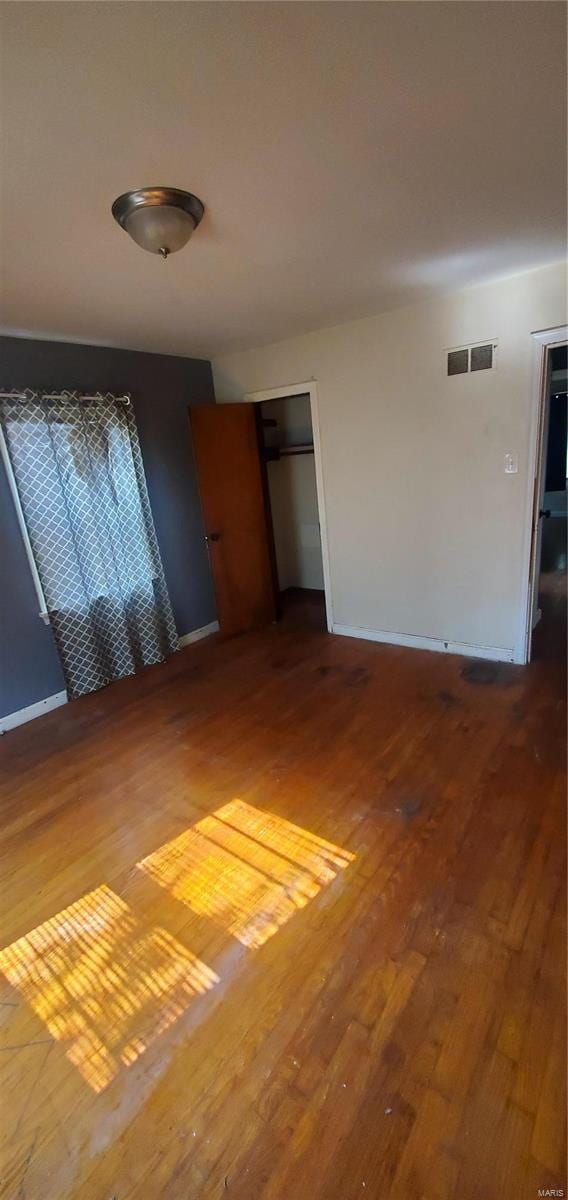 empty room with hardwood / wood-style flooring