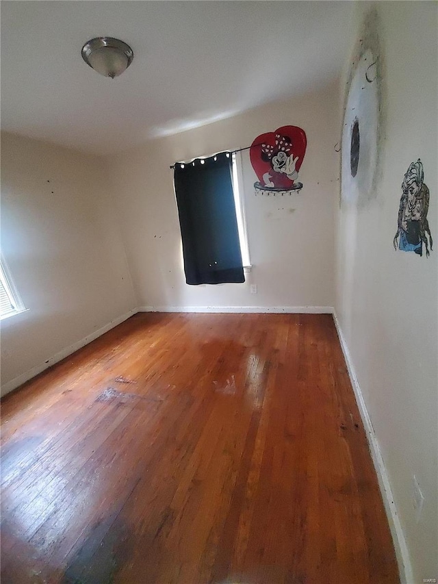 unfurnished room featuring hardwood / wood-style flooring