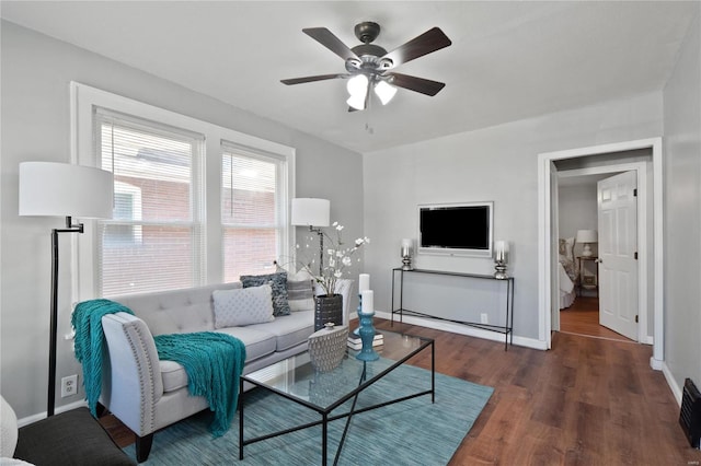 living room with ceiling fan and dark hardwood / wood-style floors