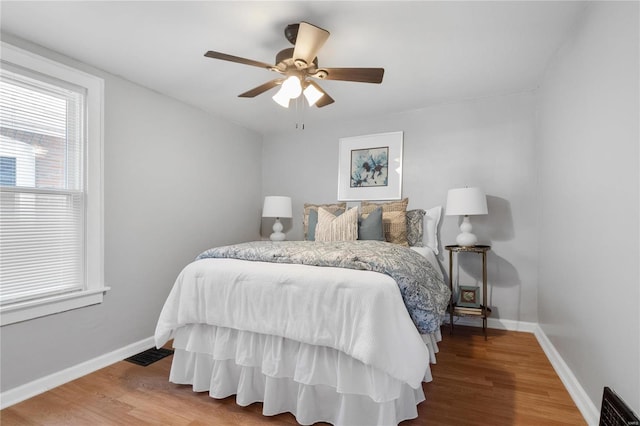 bedroom featuring ceiling fan and hardwood / wood-style flooring