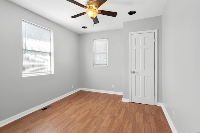 spare room with light wood-type flooring and ceiling fan