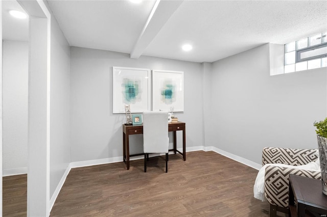 office area with a textured ceiling, beamed ceiling, and dark hardwood / wood-style flooring