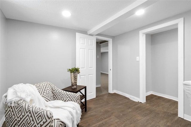 sitting room with a textured ceiling and dark hardwood / wood-style floors