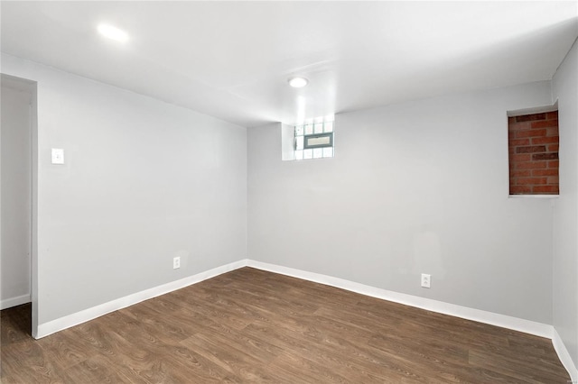 basement with dark hardwood / wood-style flooring