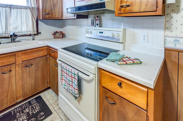 kitchen featuring light tile patterned floors, sink, and electric stove