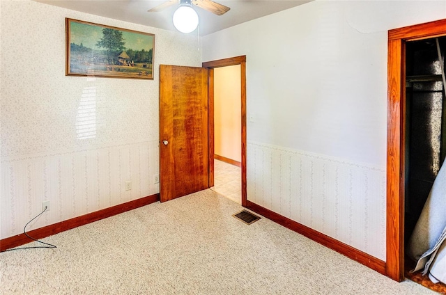 interior space featuring ceiling fan