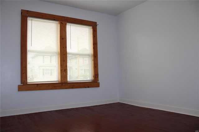 spare room with dark hardwood / wood-style floors