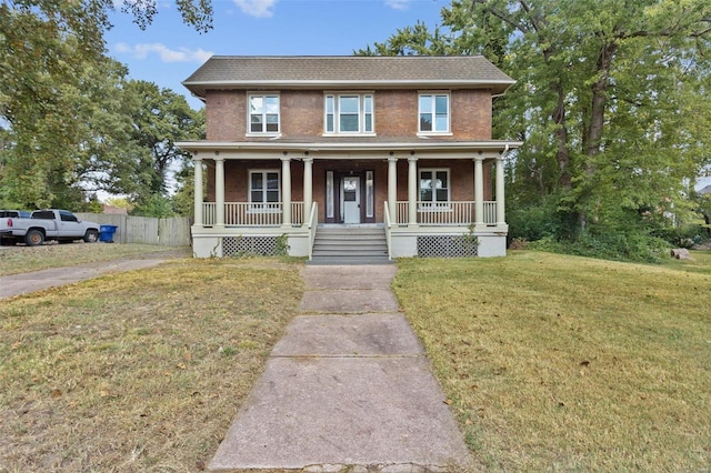 view of front facade with a front yard and a porch