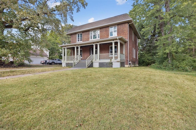 view of front of house featuring a garage, a front lawn, and covered porch