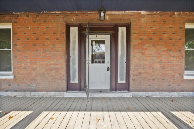 view of exterior entry featuring a deck