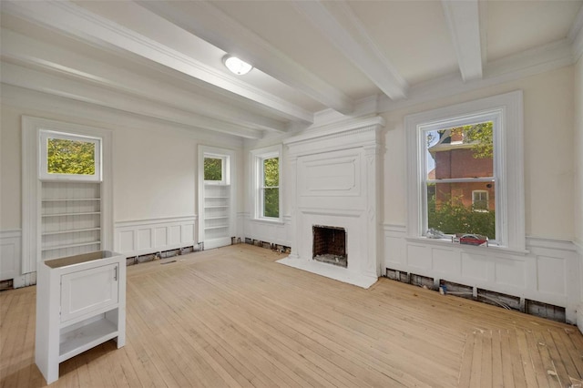 unfurnished living room featuring light wood-type flooring and a wealth of natural light