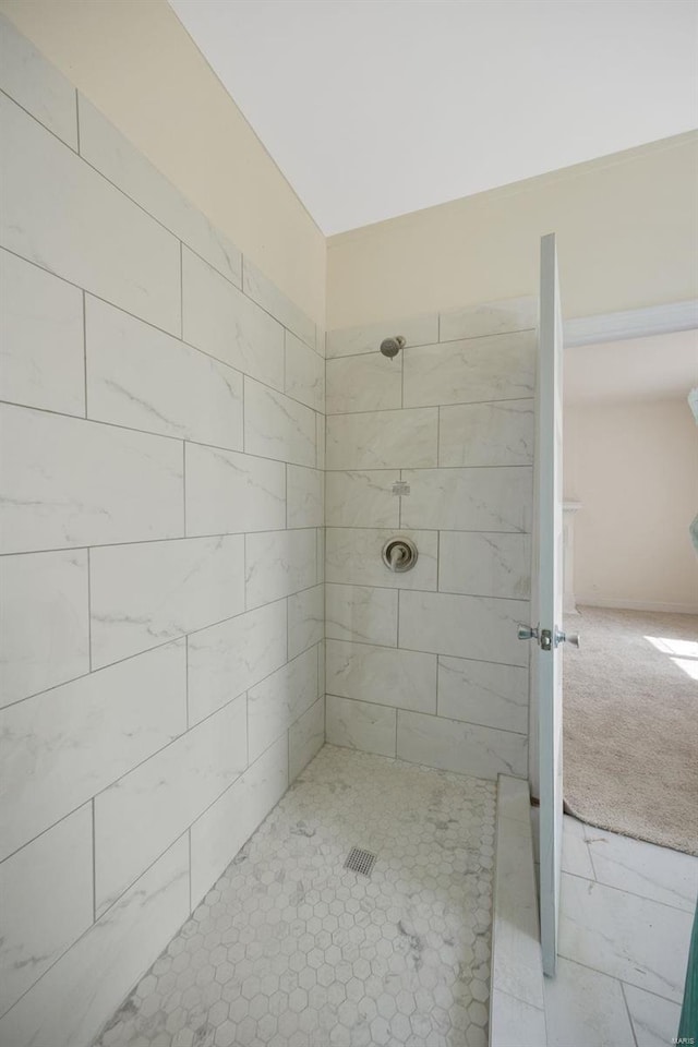 bathroom with a tile shower