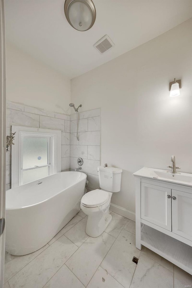 bathroom featuring tile walls, vanity, and toilet