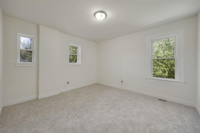 unfurnished room with light carpet