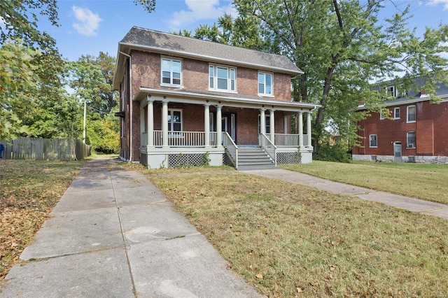 view of front facade featuring a porch and a front lawn