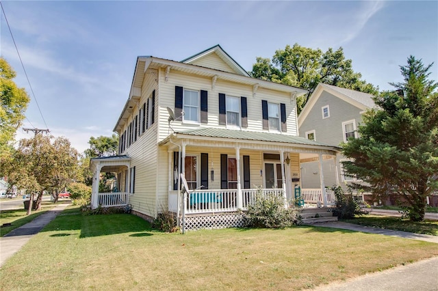 view of front of house with a front yard and a porch