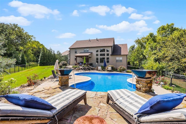 view of swimming pool featuring a lawn and a patio area