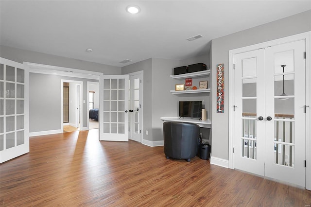 interior space with french doors and hardwood / wood-style flooring