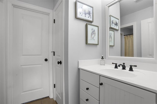 bathroom with tile patterned floors and vanity