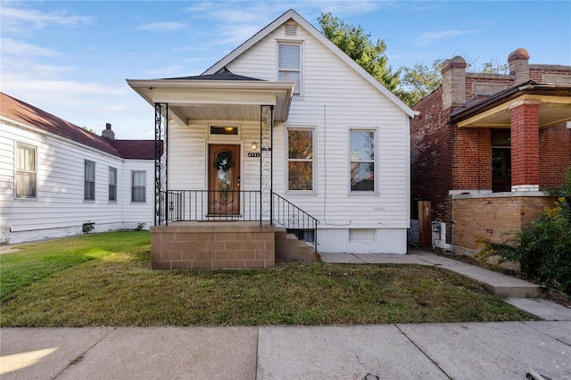 bungalow-style home featuring a front yard