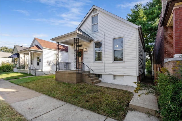 bungalow-style house with a front yard