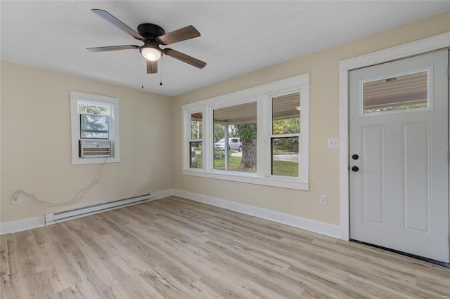 interior space with a baseboard radiator, light wood-type flooring, a healthy amount of sunlight, and ceiling fan