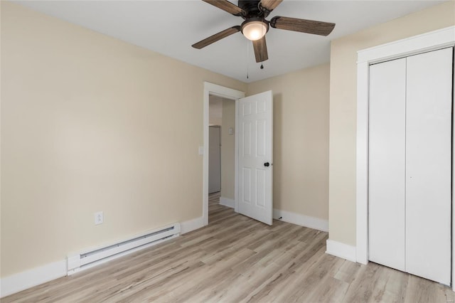 unfurnished bedroom featuring a baseboard radiator, light hardwood / wood-style flooring, a closet, and ceiling fan