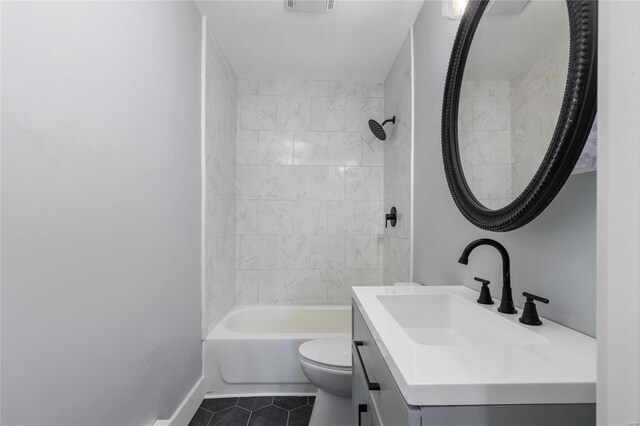 full bathroom featuring vanity, tiled shower / bath, toilet, and tile patterned floors