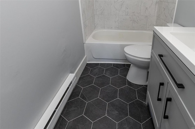 bathroom with a baseboard radiator, toilet, tile patterned floors, vanity, and a bathtub