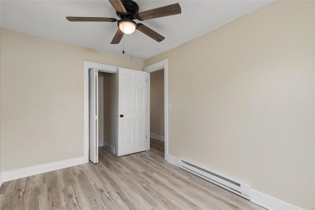 unfurnished bedroom featuring ceiling fan, light hardwood / wood-style flooring, and baseboard heating