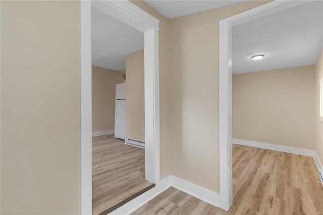 hallway featuring light hardwood / wood-style flooring and baseboard heating