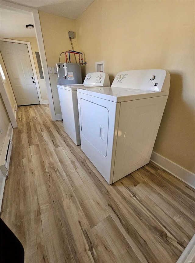 laundry room featuring light hardwood / wood-style floors, electric water heater, and washer and dryer