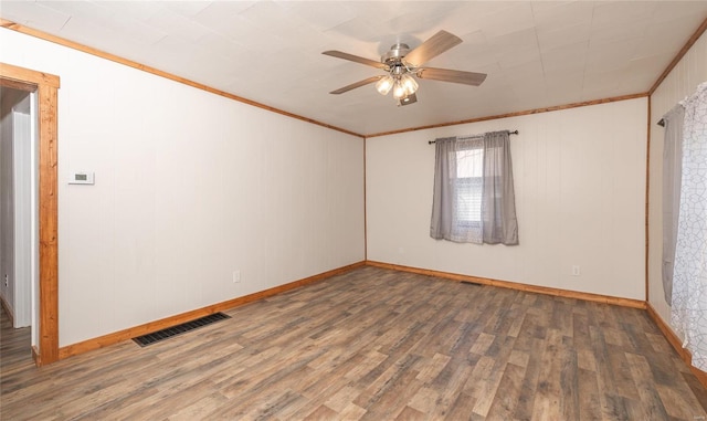 unfurnished room with ceiling fan, crown molding, and dark hardwood / wood-style flooring